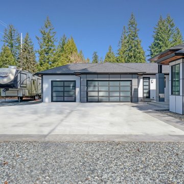 newly built home with an RV parked in the driveway